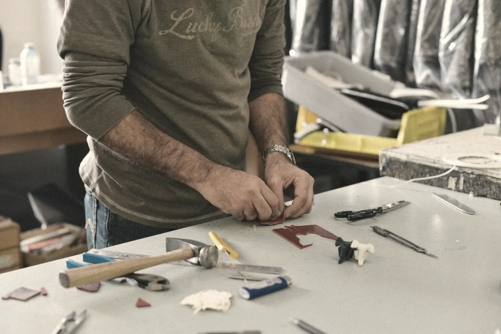 Hands assembling a product on a workshop table
