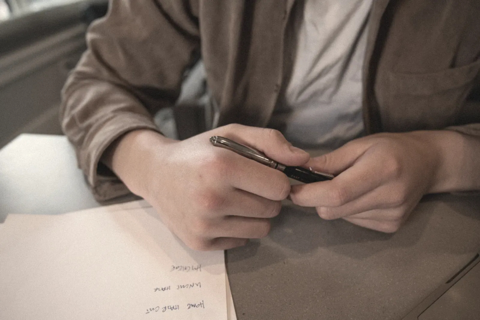 A person signing tax paperwork at a desk