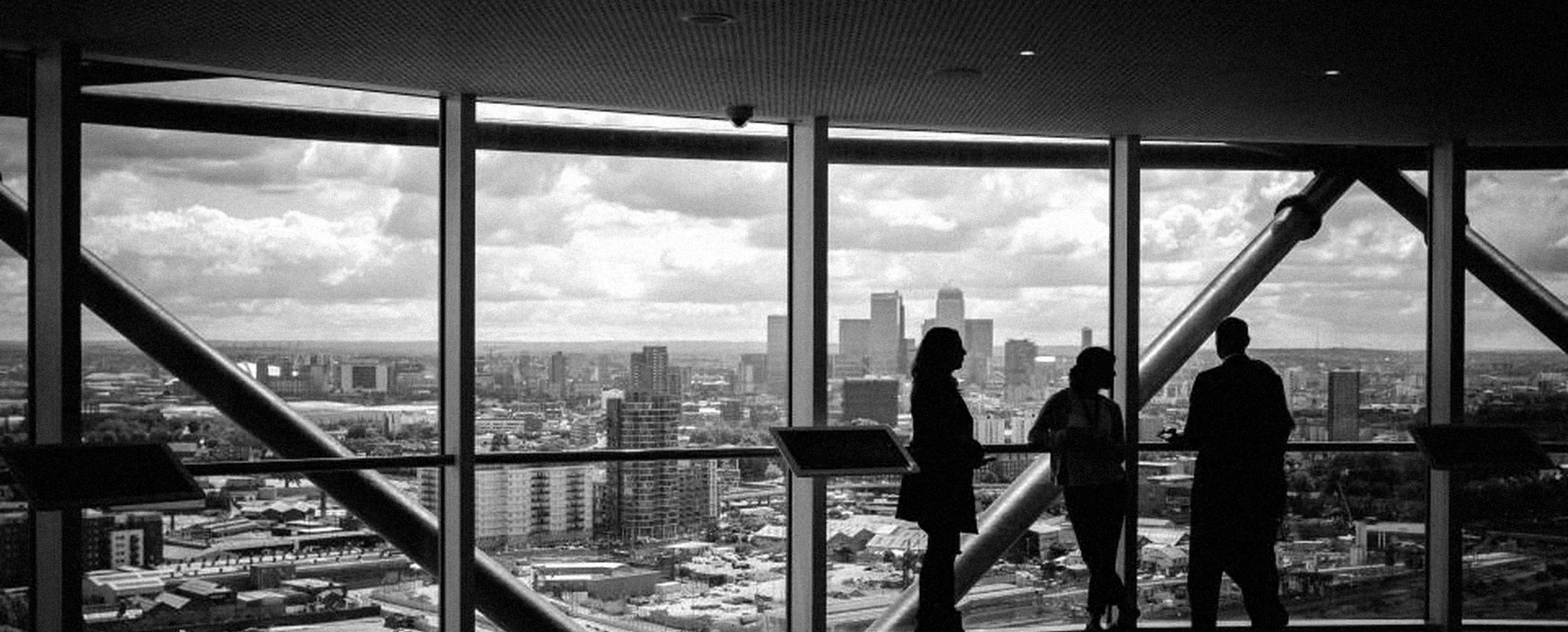 People in an office looking out over a city skyline